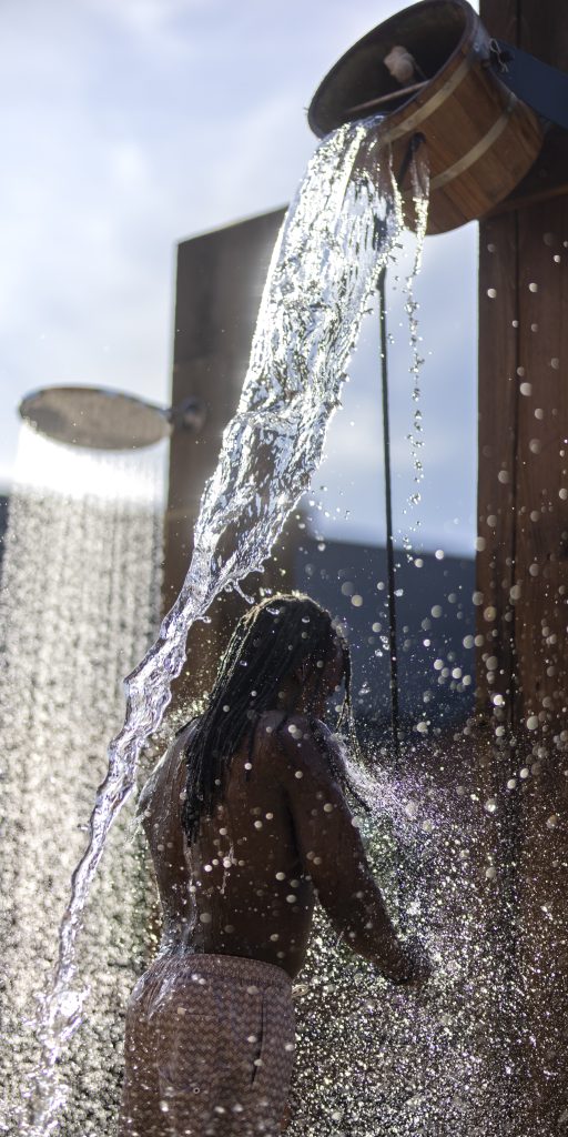 man pulling a bucket of cold water