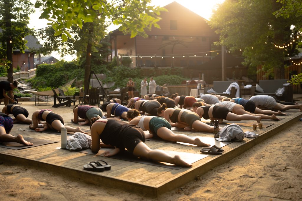 guests doing yoga at the spa in the beach area