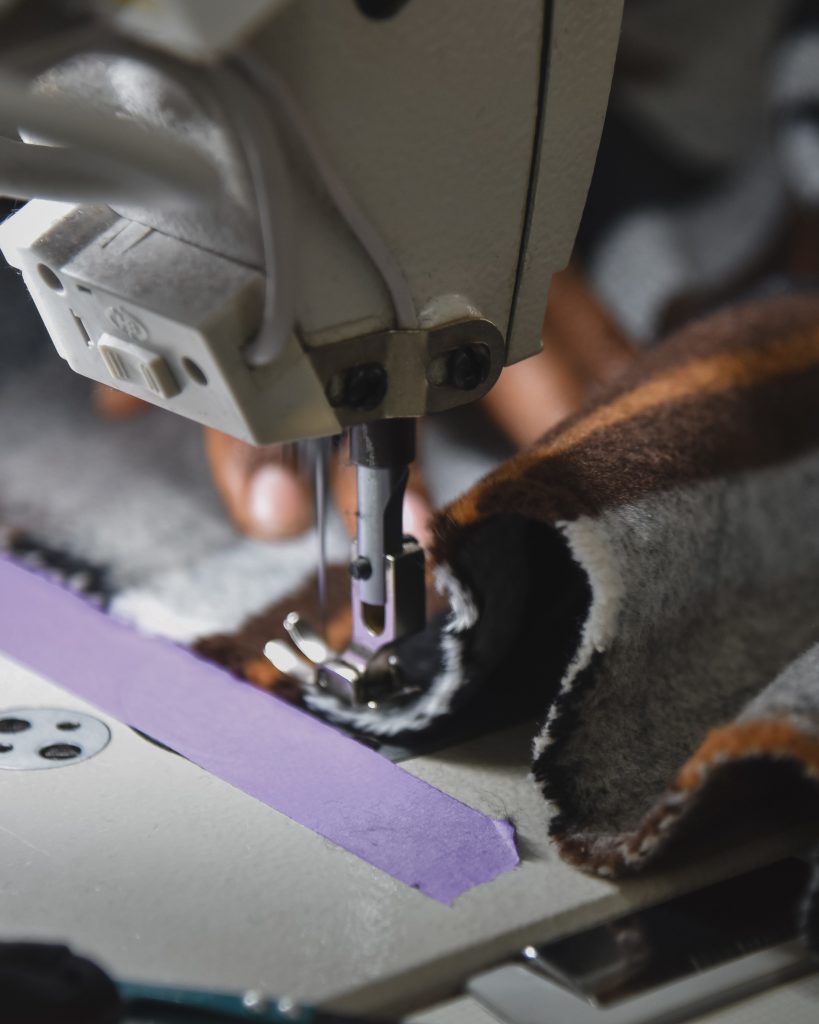 seamstress operating a sewing machine